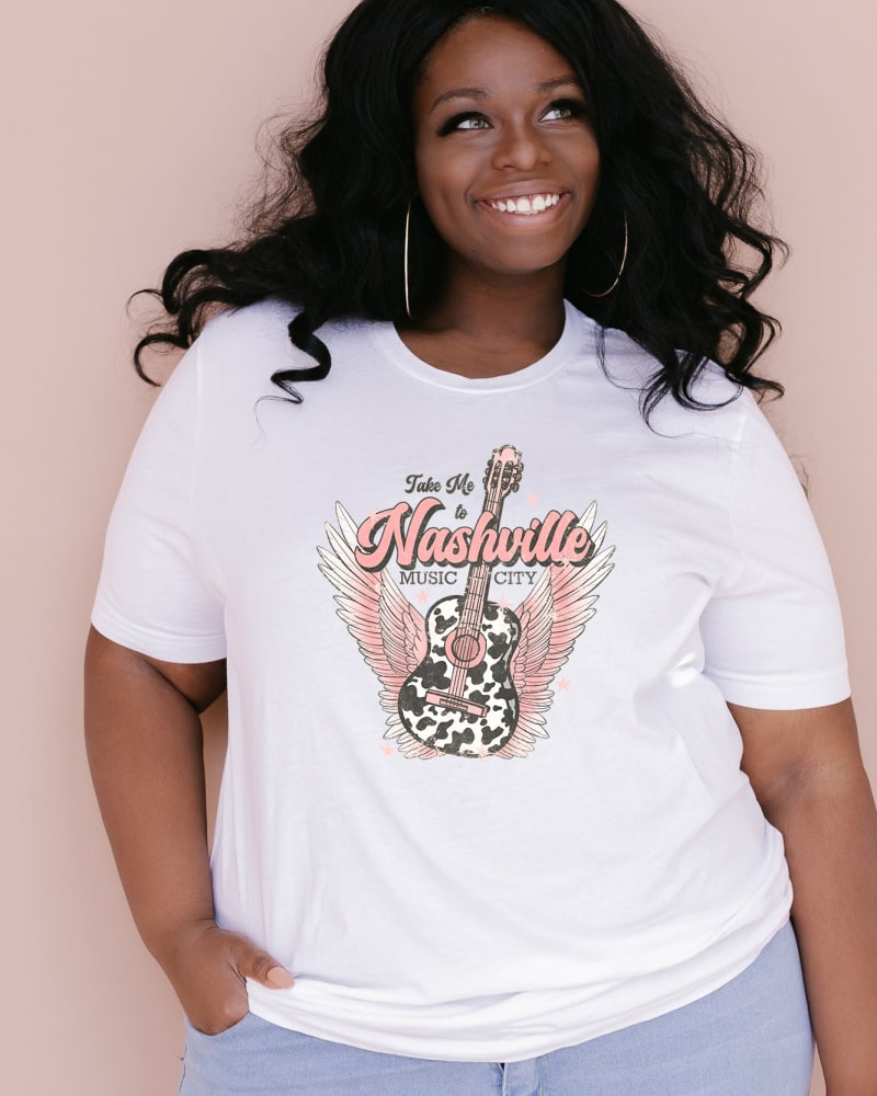 Front of a model wearing a size Large Take Me To Nashville Winged Guitar in White by Simply Sage Market. | dia_product_style_image_id:281318